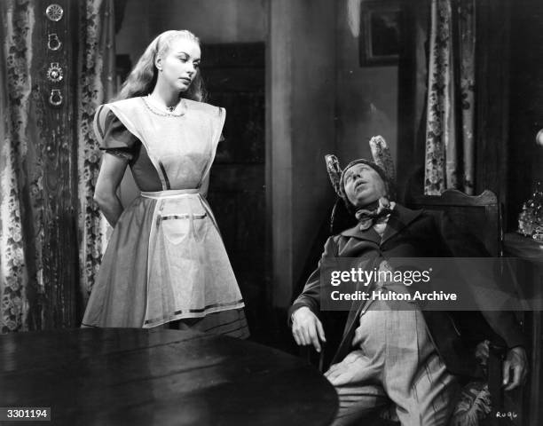 British comedian George Formby and Rosalyn Boulter star in the Columbia comedy 'George In Civvy Street', which echoes 'Alice In Wonderland'. The film...