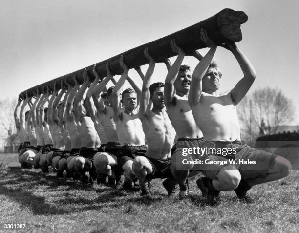 Men from the Anti-Aircraft Divisional School of Physical Training carrying a telegraph pole during training for ravine and river crossing.