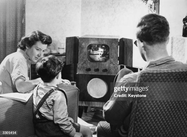 Family watching television at home.