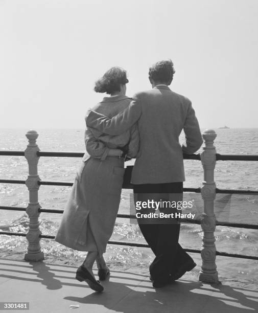 Couple looking out to sea on Blackpool Promenade. Original Publication: Picture Post - 5358 - Bert Hardy's Box Camera - pub. 1951