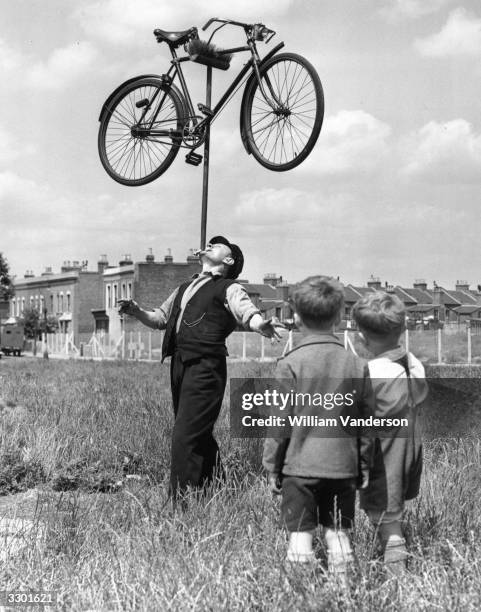 In the field outside his house in Plaistow, East London, 62-year-old railway worker Mo Harris balances a bicycle on top of a broom on his chin,...