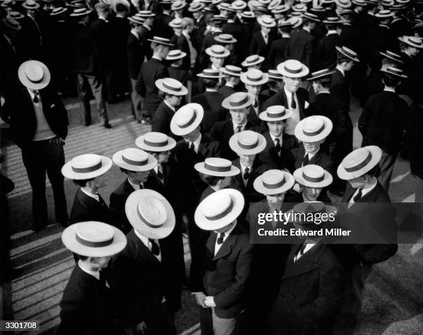 Crowd of Harrow schoolboys wearing their traditional straw boater hats during the Founder's Day celebrations.