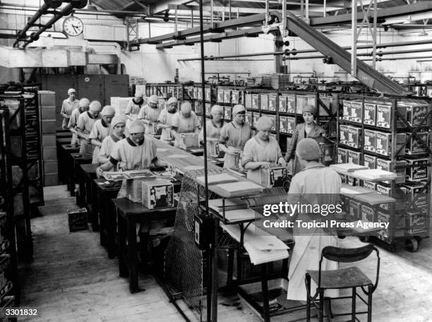 Workers label tins at the Jacob's Biscuit factory in Aintree, Liverpool.