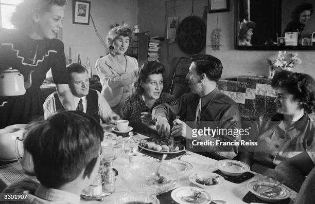 Soldier Sergeant Fournier dining with the family of his English bride before setting sail for America. Original Publication: Picture Post - 2091 -...