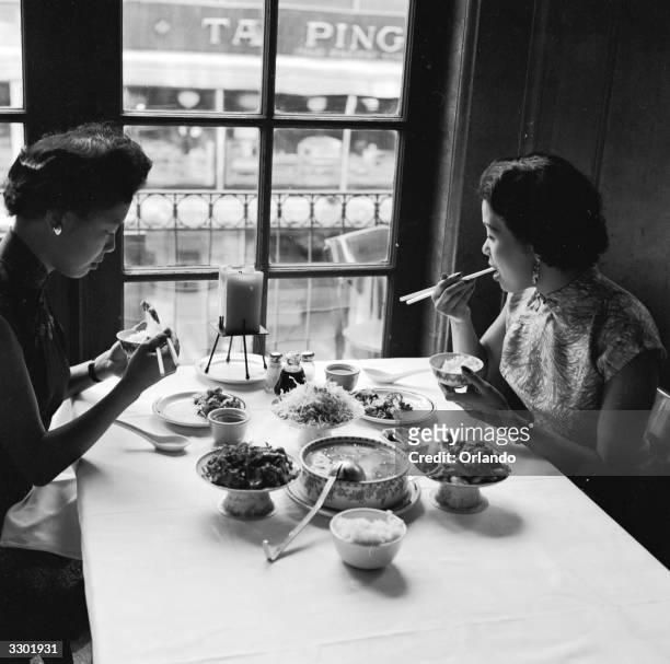 Two women sample the bird's nest soup and other delicacies on offer at Johnny Kan's famous Chinese restaurant in Chinatown, San Francisco.