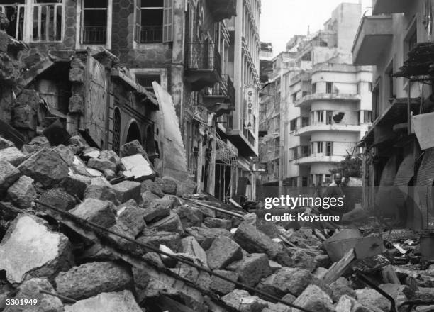 One of Beirut's narrow streets piled high with rubble after a civil war.