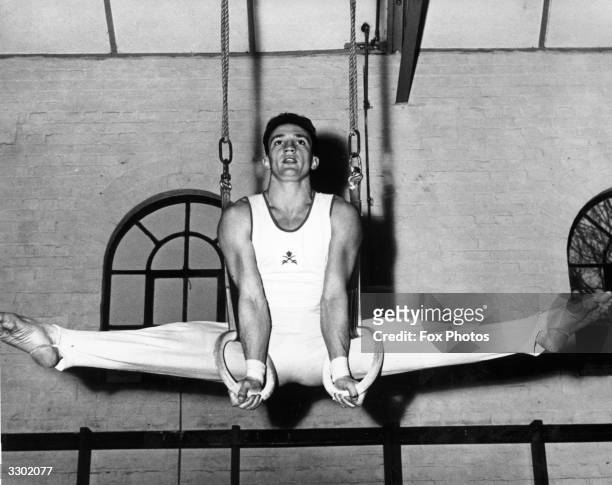Staff sergeant Dick Gradley, a gymnastics instructor at the Army School of Physical Training, does the splits in the gym at Aldershot. A member of...