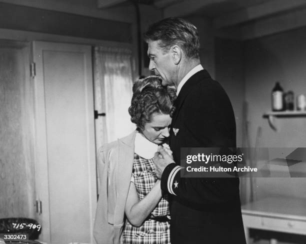 Jane Wyatt and Gary Cooper in an emotional scene from the film 'Task Force', directed by Jerry Wald for Warner.