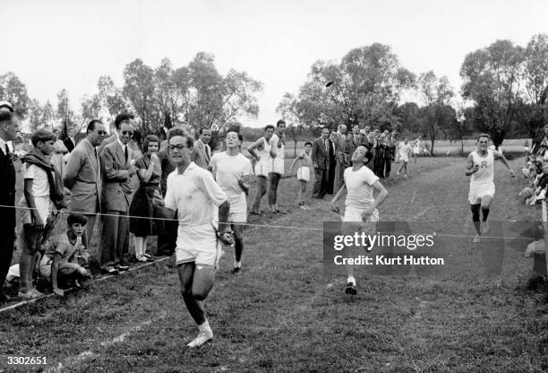 Anym Aga Khan about to break the tape in a race at Le Rosey, an exclusive boys' school in Switzerland. Original Publication: Picture Post - 6609 -...