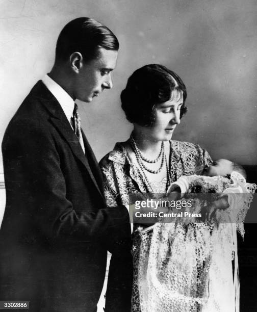Future King and Queen, George, Duke of York and Elizabeth Duchess of York holding their first child, future Monarch Princess Elizabeth at her...