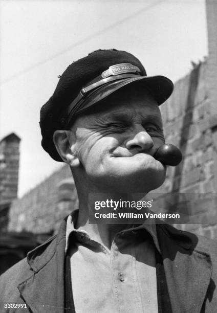 Mo Harris, a 62 year-old railway worker from Plaistow in East London, gurning in the manner of Popeye. Harris, who is known as 'the chin-up boy of...