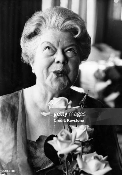 Actress Violet Carson, who created the role of Ena Sharples in 'Coronation Street', appreciates the rose named after her the previous night at...