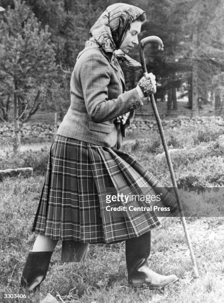 Queen Elizabeth II walking cross country at the North of Scotland Gun Dog Association Open Stake Retreiver Trials in the grounds of Balmoral Castle.