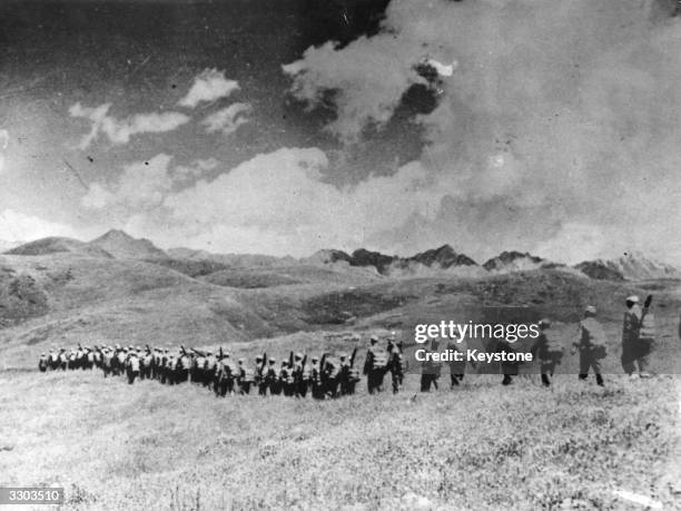 Chinese troops march over the highlands towards the Tibetian frontier after their invasion of Tibet.