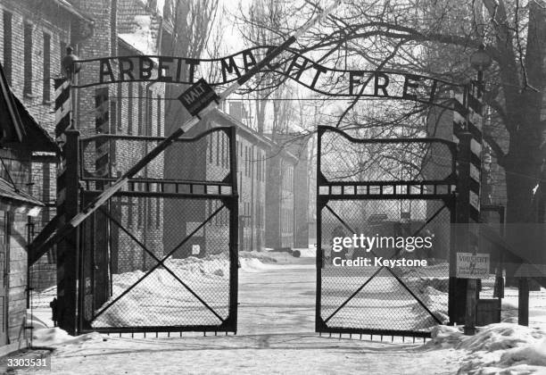 The gates of the Nazi concentration camp at Auschwitz, Poland, circa 1965. The sign above them is 'Arbeit Macht Frei' - 'Work Makes You Free'.