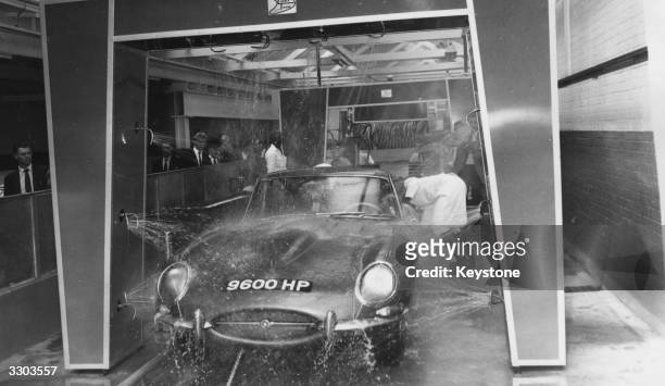 Britain's first automatic car wash and high density laundry at St George's Garage Brompton Road, London, with an E type Jaguar going through the...
