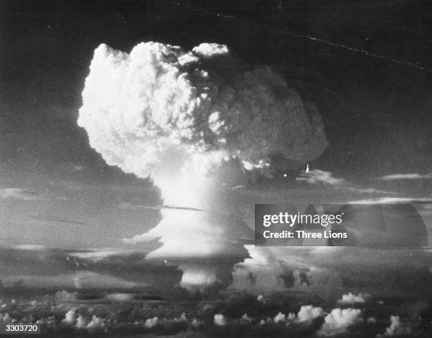 Characteristic mushroom shaped cloud begins formation after the first H-Bomb explosion at Eniwetok Atoll in the Pacific.