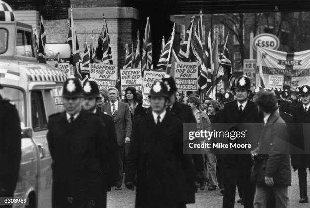 National Front march in Camberwell New Road, London. The placards read; 'Defend Our Old Folk, Repatriate Muggers'.