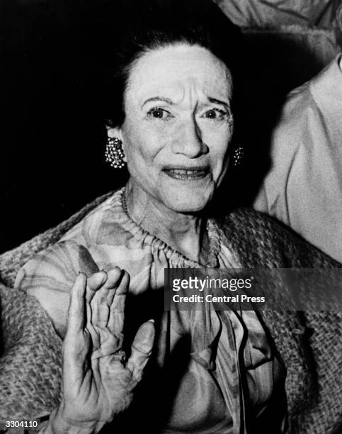The Duchess of Windsor , dining with friends at the Paris nightclub Maxim's.