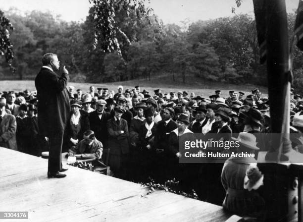 Theodore Roosevelt American statesman and President, addressing a suffragette rally from the verandah of his home.