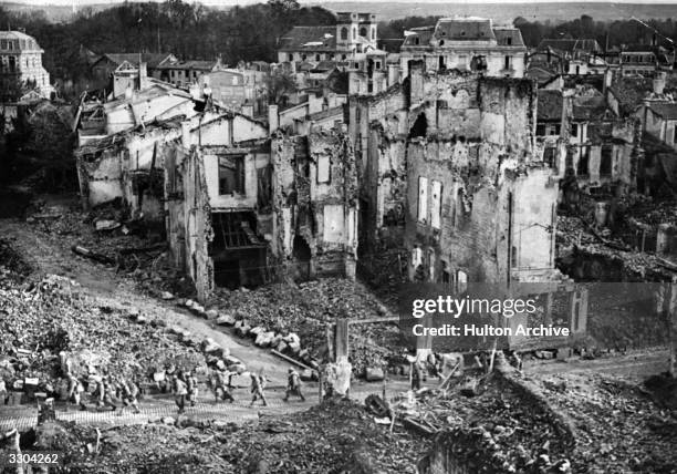 French troops passing through ruins at Verdun.