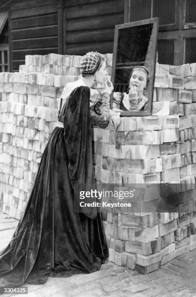 Valerie Williams leaning on a pile of bricks to putt on make up for her role as Tormalind in 'As You Like It' before an open air production at George...