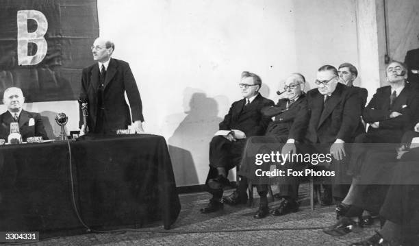 The Labour Cabinet, with left Emanuel Shinwell, standing Prime Minister Clement Attlee seated left to right Herbert Morrison, Arthur Greenwood,...