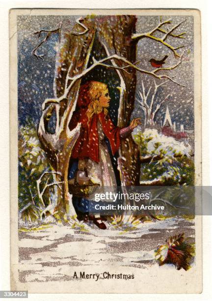 Christmas greetings card showing a girl in a red cape sheltering from the snow in a hollow tree.