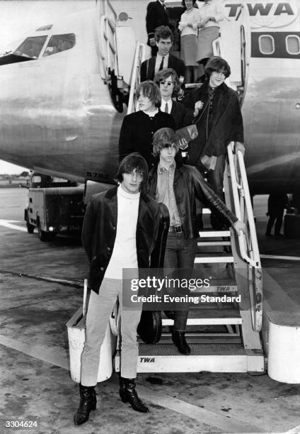 American folk-rock pop group The Byrds disembarking from a TWA aeroplane.