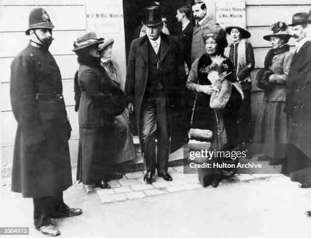 The English suffragette Emmeline Pankhurst , leaves the court at Epsom with James Murray, a former member of parliament who stood bail for her.