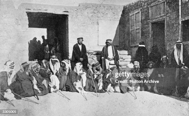 British soldier, author and adventurer Thomas Edward Lawrence and the Emir Faisal king of the Helaz, later Faisal I, King of Iraq, confer with...