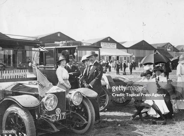 Irish journalist and newspaper magnate Alfred Charles William Harmsworth , 1st Viscount Northcliffe, at Brooklands race course with Lady Nancy Astor...