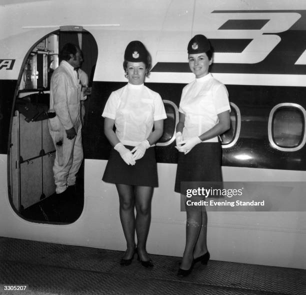 Air hostesses at work just before welcoming boarding passengers onto the plane.