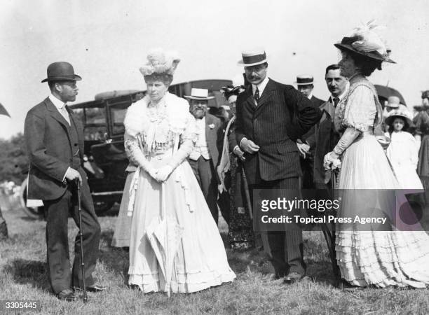 King George V, , who ascended the British throne in 1910, then Prince of Wales, with his queen-consort Queen Mary, , then Princess of Wales, with Mr...