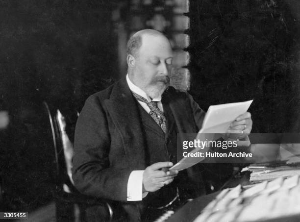 King Edward VII, , who ascended the British throne in 1901, as Prince of Wales, reading at Sandringham, Norfolk.