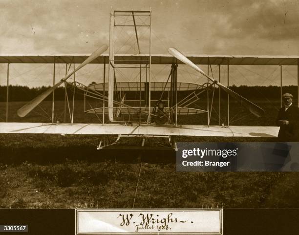 Wilbur Wright standing in front of the Wright Flyer II biplane. Aeroplane Album - Vol 2 Page 50