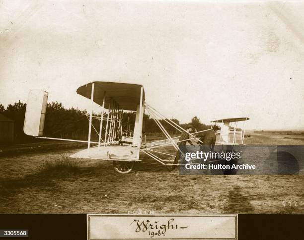 The Wright Flyer II biplane on wheels being pulled out onto a field. Aeroplane Album - Vol 2 Page 52