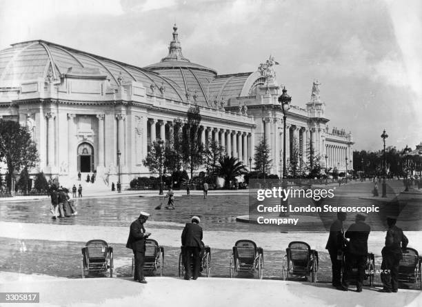 General view of the, Grand Palais, built for the Paris Exhibition, 1900 with bath chairs and attendants in the foreground.