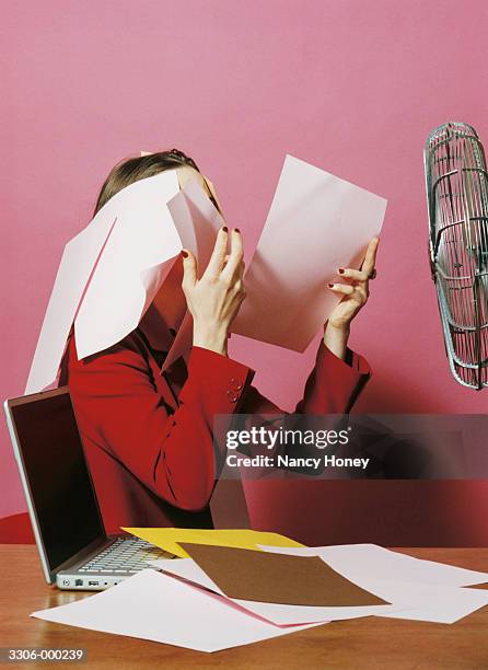 woman with paper blowing away - electric fan paper stock pictures, royalty-free photos & images