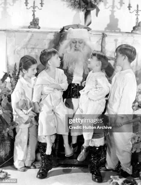 Four of Paramount's child actors are visiting Santa Claus to put in their requests. They are, left to right, Virginia Weidler , Baby LeRoy, Billy Lee...