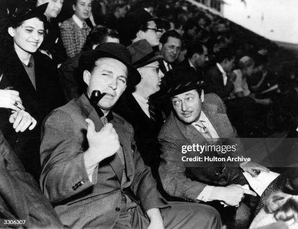 Bing Crosby the film star, actor and singer at a football match with Edmund Lowe.