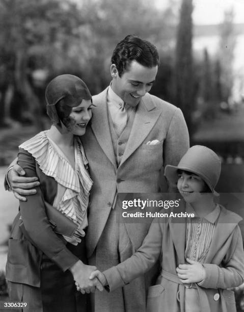 Mitzi Green the child performer, Charles Buddy Rogers, the leading man and Mary Brian, the leading lady meet at the Paramount film studios. Mitzi...