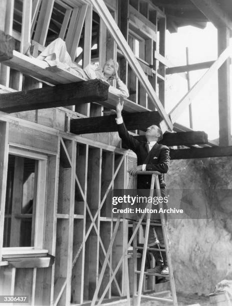 Ann Harding the Hollywood film actress with her husband Harry Bannister, who is also an actor, seen here at the Hollywood hill-top house they are...