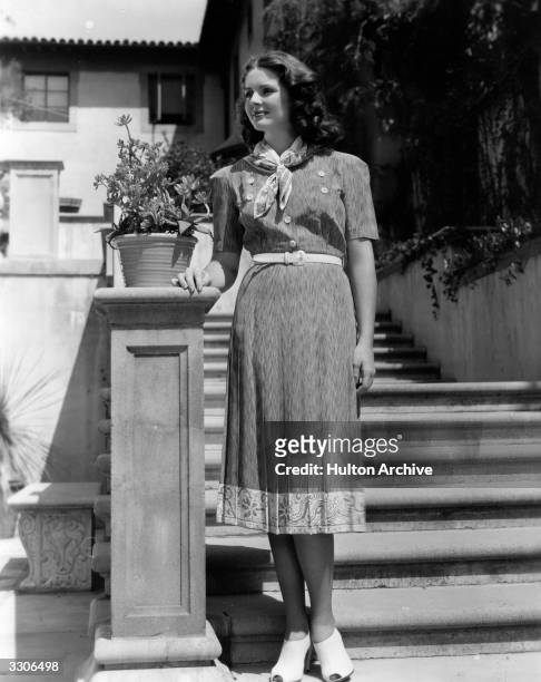 Arleen Whelan the American leading lady of the 40's who was formerly a manicurist is pictured standing at the bottom of a flight of stone steps.