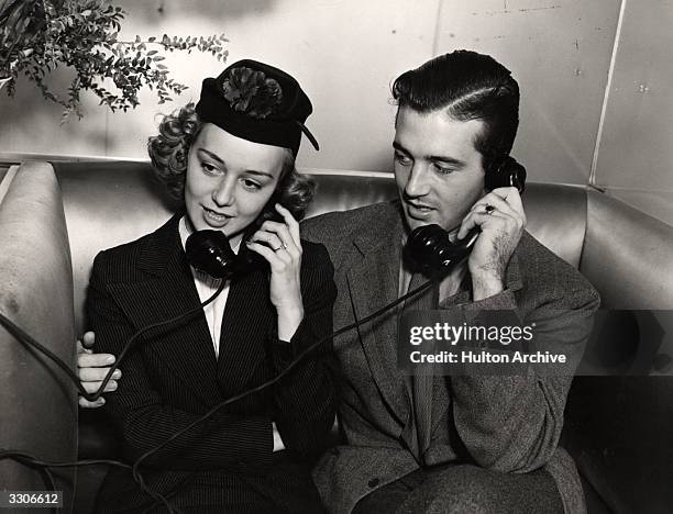 Anne Shirley the Hollywood actress, joins John Payne her husband and fellow thespian, in a phone call.