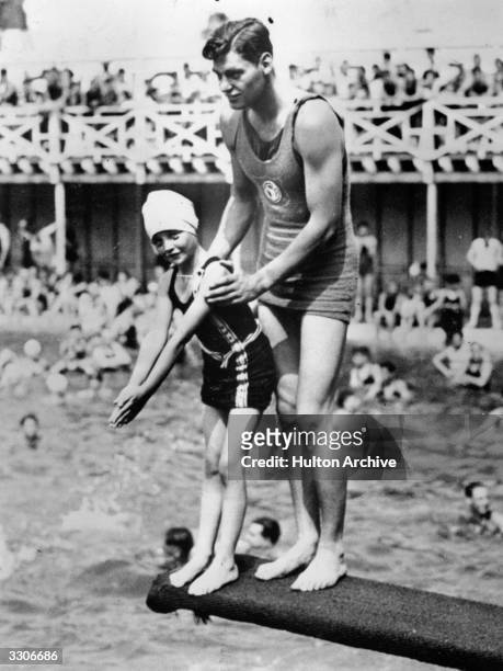 Johnny Weissmuller the stage name of Peter John Weissmuller, the former Olympic athlete and star of the 'Tarzan' movies. He is seen here at an...