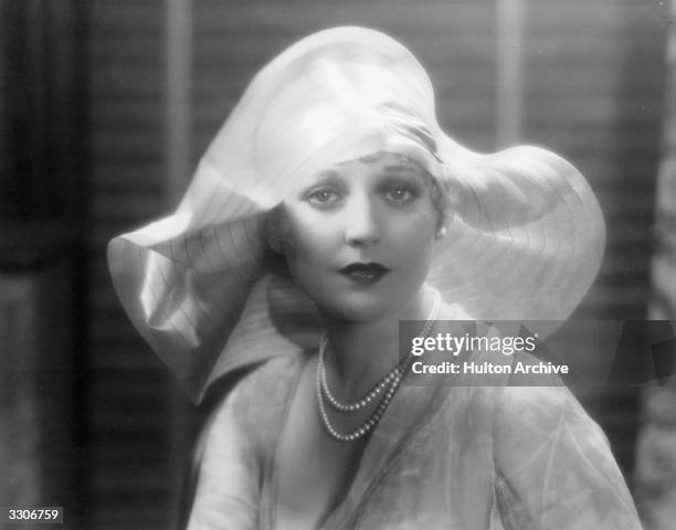 Thelma Todd the perky leading lady and heroine of many two-reel comedies with First National. She is wearing a delicate wide-brimmed hat and has just...