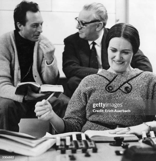 Carlo-Maria Giulini, Walter Legge and Joan Sutherland listening to a playback at a recording session of Mozart's opera 'Don Giovanni', in London.