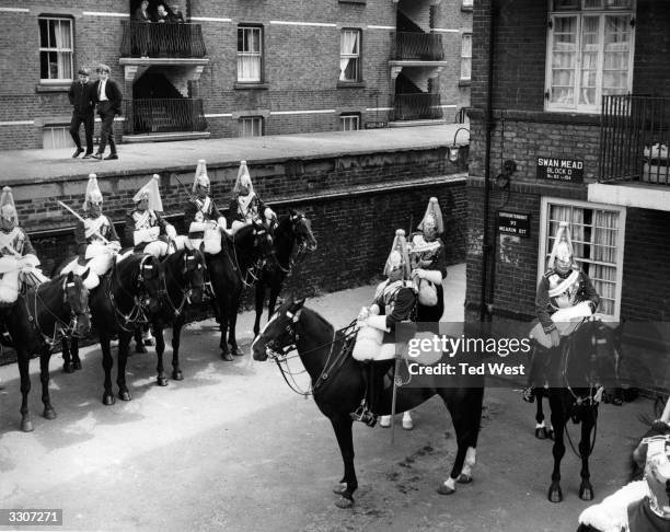 Troop of Life Guards of the Household Cavalry visit Bermondsey in London's East End, much to the amusement of local boys. The occasion was as part of...