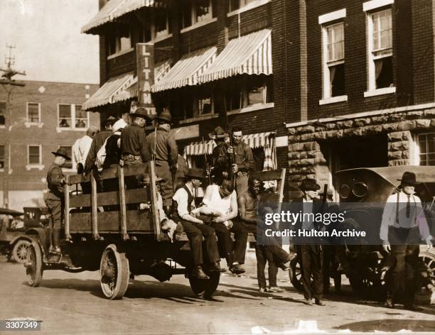 Injured and wounded men are being taken to hospital by National guardsmen after racially motivated riots, also known as the "Tulsa Race Massacre",...